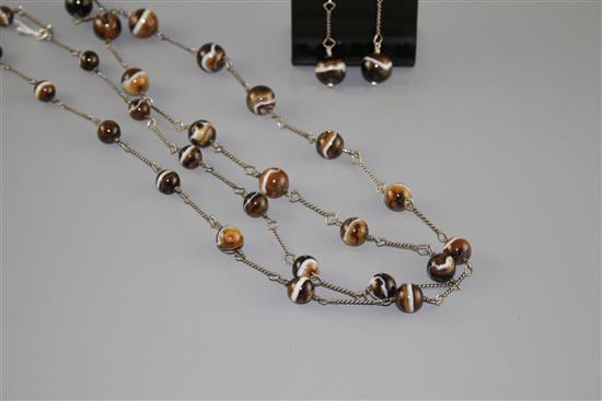 A white metal and graduated banded agate bead long necklace and pair of matching earrings, necklace 130cm, earrings 55mm.